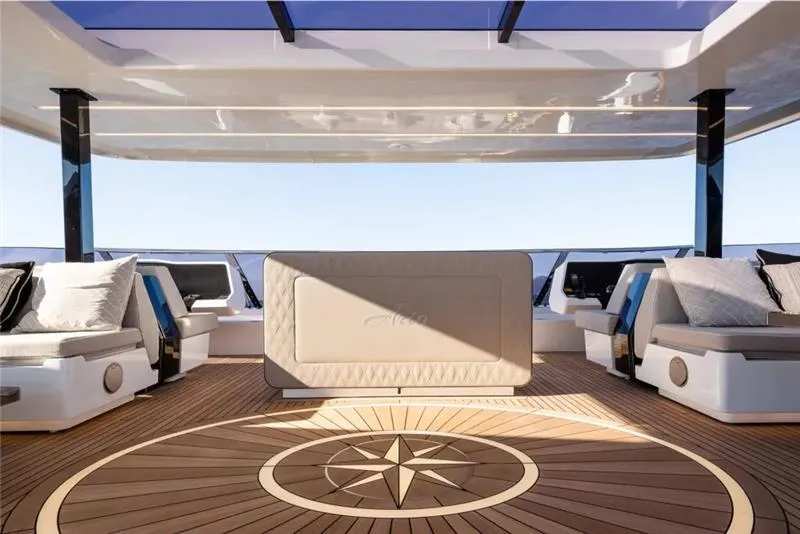 Slide: The Image of Luxurious 2026 Sunreef 80 Sunreef Power yacht deck with elegant seating and compass design. - 12