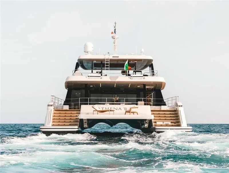 Slide: The Image of 2026 Sunreef 80 Power yacht cruising on open sea, rear view. - 3