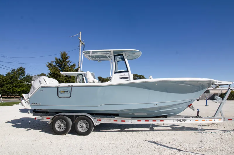 The Image of 2026 Sea Hunt Gamefish 25 boat on trailer, side view, clear sky background. - 0