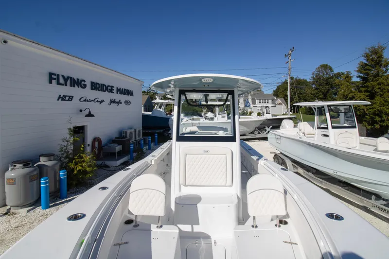 Slide: The Image of 2026 Sea Hunt Gamefish 25 at Flying Bridge Marina, surrounded by other boats. - 1