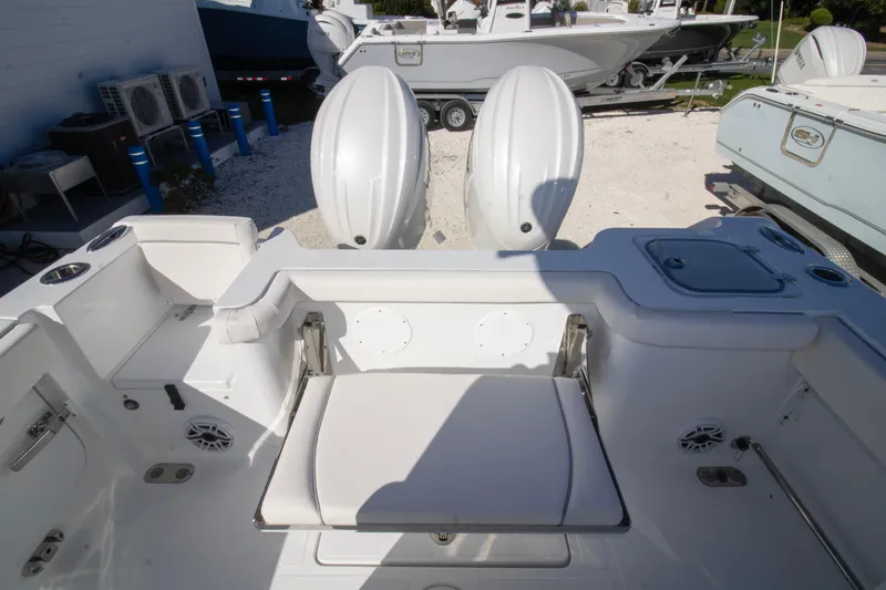 Slide: The Image of 2026 Sea Hunt Gamefish 25 boat interior with dual engines and seating area. - 12