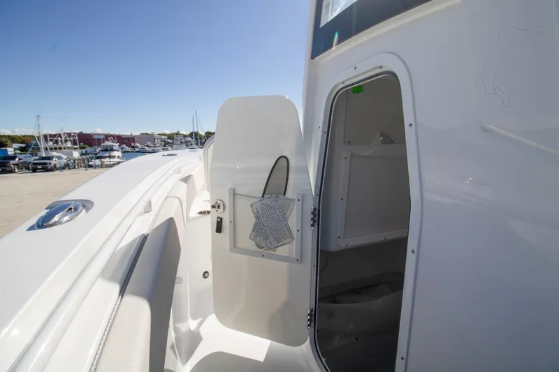 Slide: The Image of 2026 Sea Hunt Gamefish 25 boat interior with open storage compartment. - 14