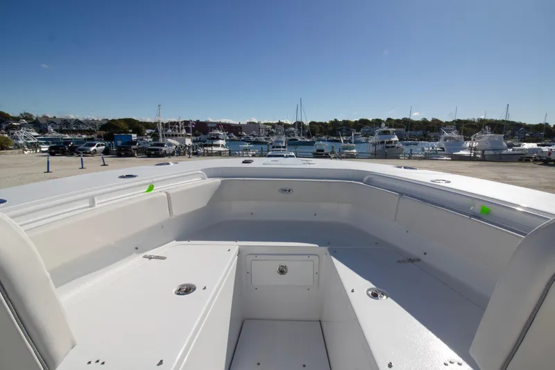 Slide: The Image of 2026 Sea Hunt Gamefish 25 boat interior with marina view in the background. - 2