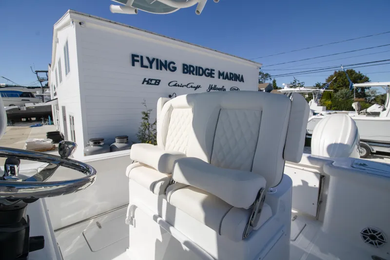Slide: The Image of 2026 Sea Hunt Gamefish 25 at Flying Bridge Marina, featuring luxurious seating and steering wheel. - 4