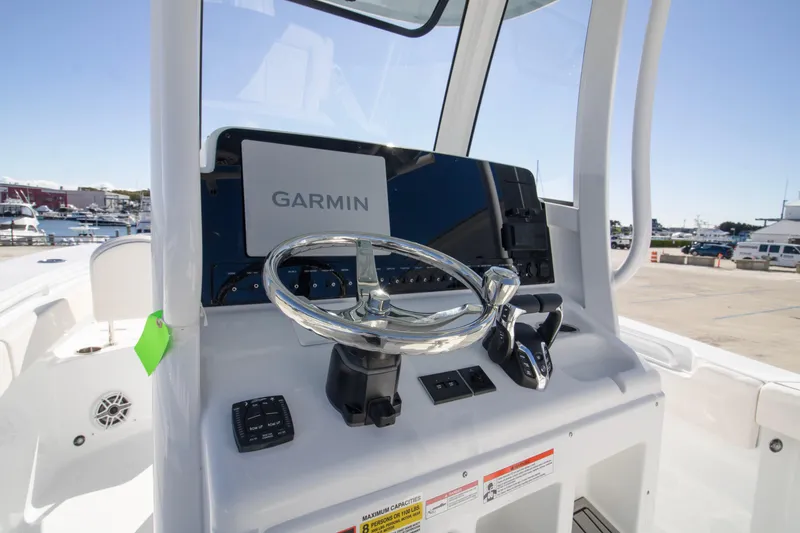 Slide: The Image of 2026 Sea Hunt Gamefish 25 helm with Garmin navigation system and sleek steering wheel. - 8
