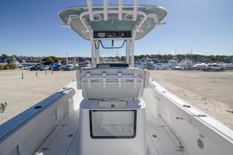 Slide: The Image of 2026 Sea Hunt Gamefish 25 boat interior at marina, showcasing helm and seating area. - 9