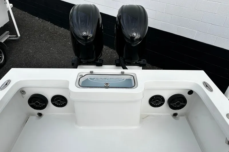 Slide: The Image of 2024 Pair Customs 24DV boat with dual engines and integrated speakers. - 13