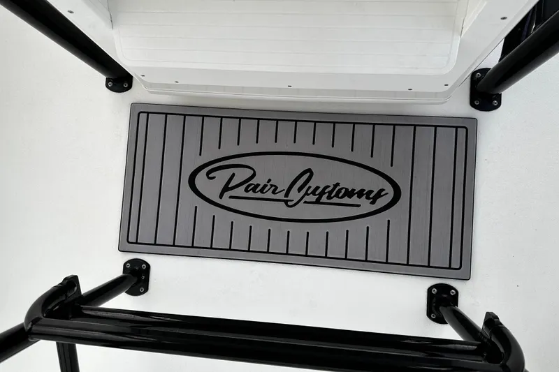 Slide: The Image of 2024 Pair Customs 24DV boat deck with branded mat and sleek design. - 15