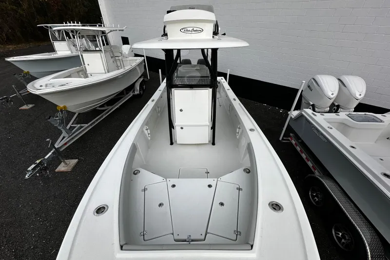 Slide: The Image of 2024 Pair Customs 24DV boat, white exterior, docked alongside other boats. - 17