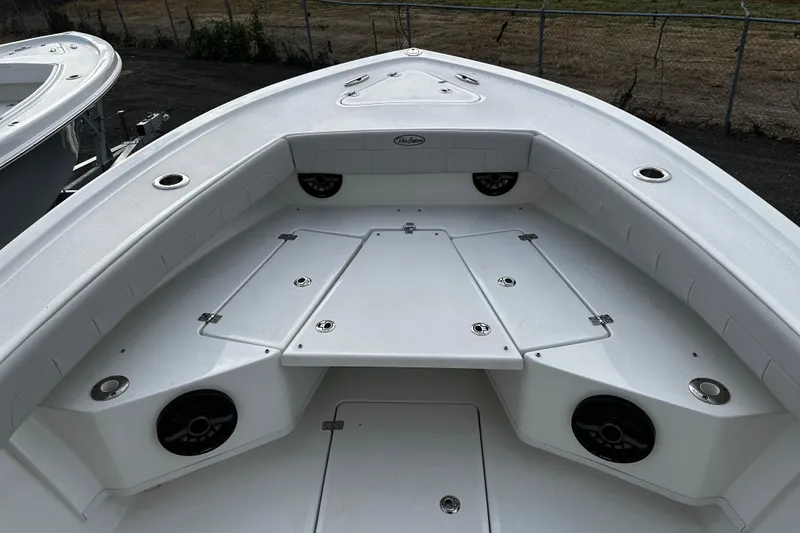 Slide: The Image of 2024 Pair Customs 24DV boat interior with seating and storage compartments. - 18