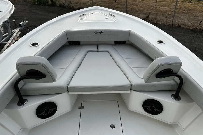 Slide: The Image of 2024 Pair Customs 24DV boat interior with cushioned seating and cup holders. - 20