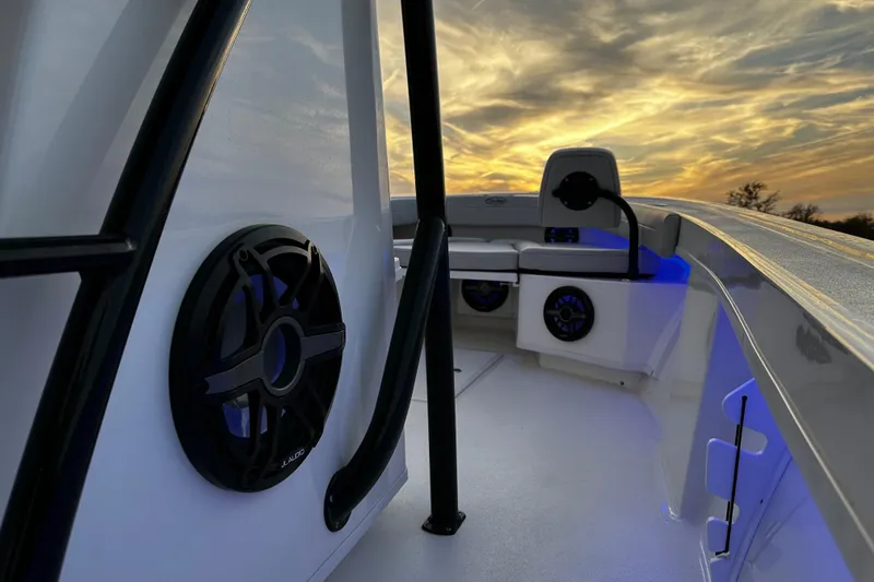 Slide: The Image of 2024 Pair Customs 24DV boat interior with speakers, sunset view. - 22