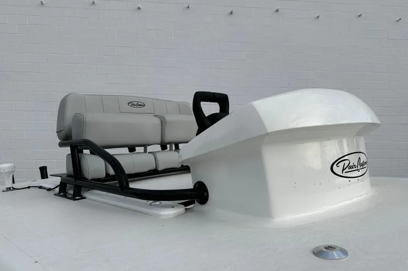 Slide: The Image of 2024 Pair Customs 24DV boat seating and console against a white brick wall. - 25