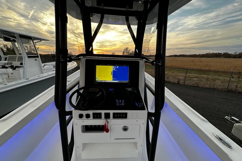 Slide: The Image of 2024 Pair Customs 24DV boat interior with navigation system at sunset. - 7
