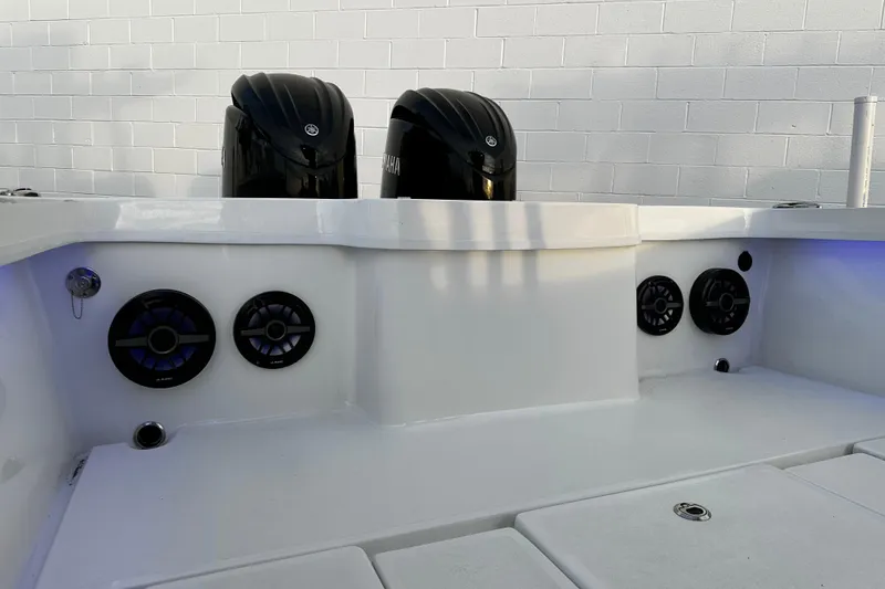 Slide: The Image of 2024 Pair Customs 24DV boat with dual engines and integrated speakers. - 14