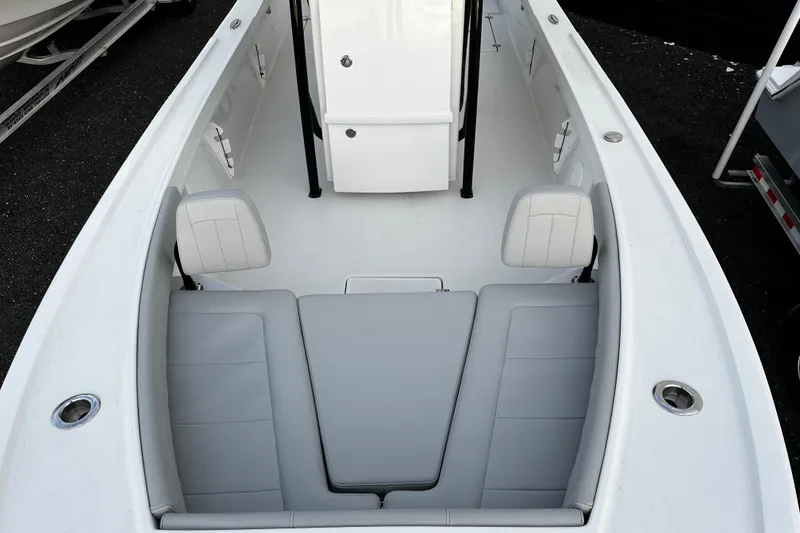Slide: The Image of 2024 Pair Customs 24DV boat interior with white seating and sleek design. - 19