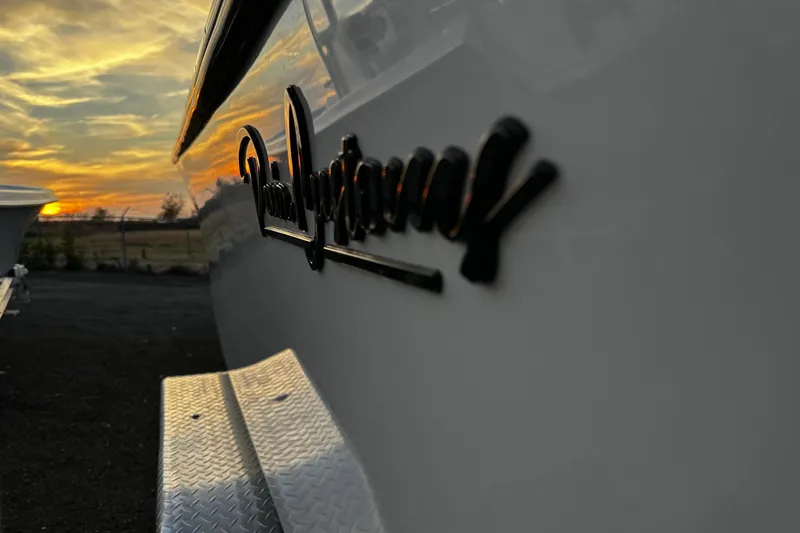 Slide: The Image of 2024 Pair Customs 24DV boat with sunset reflection on its sleek exterior. - 26