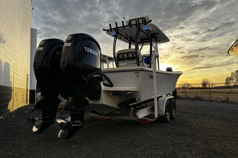 Slide: The Image of 2024 Pair Customs 24DV boat with dual Yamaha engines at sunset. - 3