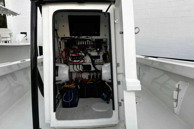 Slide: The Image of Interior view of 2024 Pair Customs 24DV boat showing electrical wiring and components. - 30