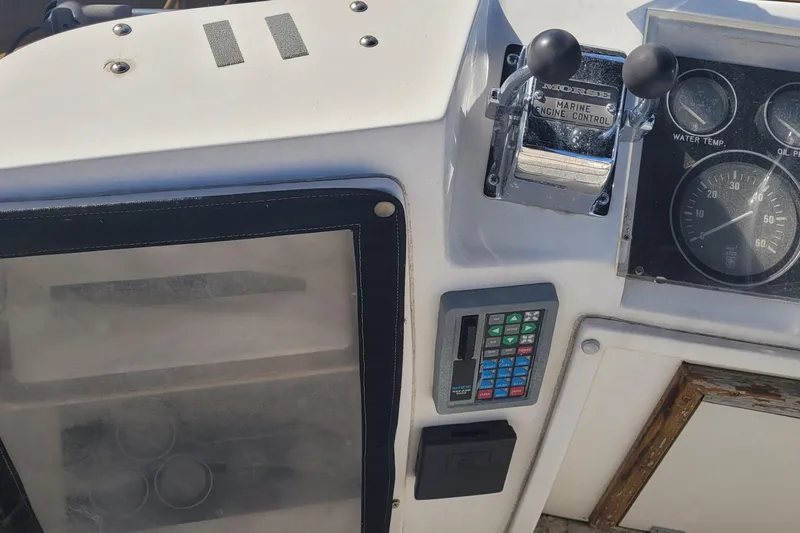 Slide: The Image of Control panel of a 1990 Phoenix 29 SFX Convertible boat with gauges and switches. - 21