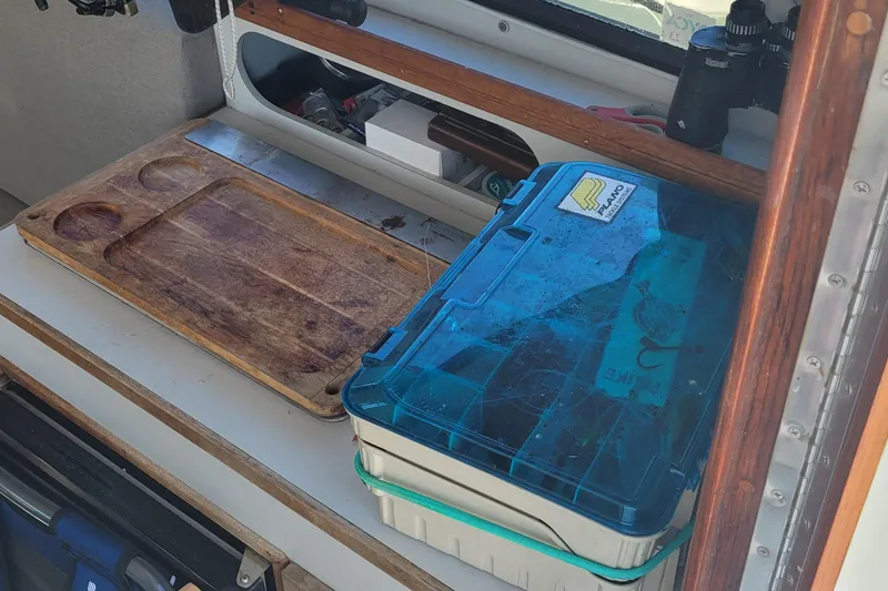 Slide: The Image of Interior of 1990 Phoenix 29 SFX Convertible with cutting board and tackle box. - 24