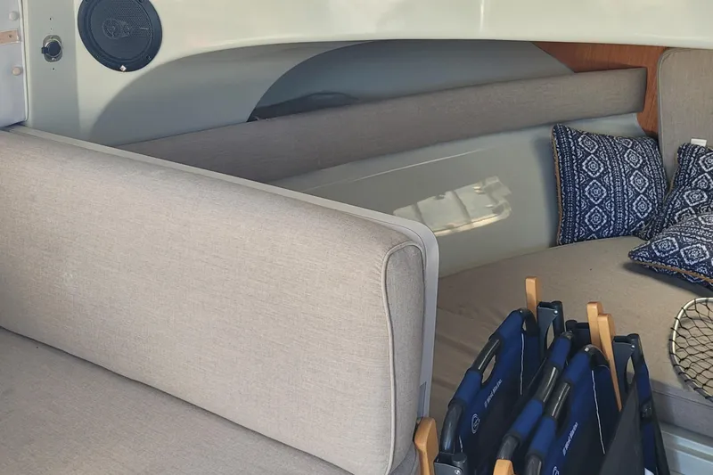 Slide: The Image of Interior of 1990 Phoenix 29 SFX Convertible with seating, cushions, and speaker. - 26