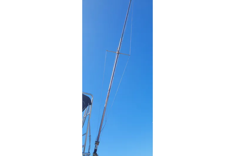 Slide: The Image of Antenna on 1990 Phoenix 29 SFX Convertible against clear blue sky. - 35