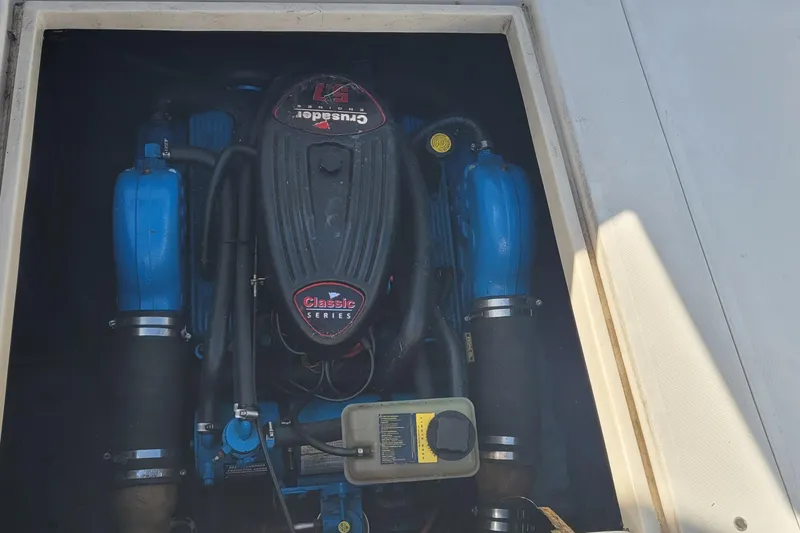 Slide: The Image of Engine compartment of a 1990 Phoenix 29 SFX Convertible boat, featuring Crusader Classic Series engine. - 37