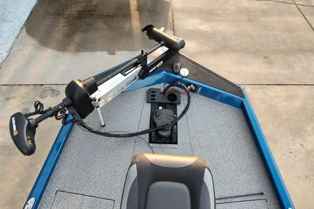 Slide: The Image of 2021 Lund 1775 Renegade boat with trolling motor and seating, docked on concrete. - 4