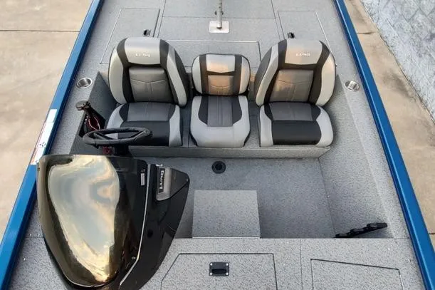 Slide: The Image of 2021 Lund 1775 Renegade boat interior with three seats and steering console. - 6