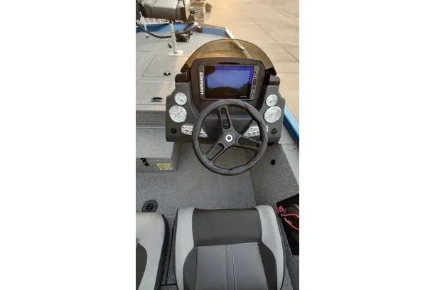 Slide: The Image of 2021 Lund 1775 Renegade boat dashboard with steering wheel and navigation display. - 7
