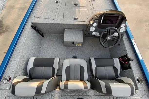 Slide: The Image of 2021 Lund 1775 Renegade boat interior with three seats and steering console. - 9