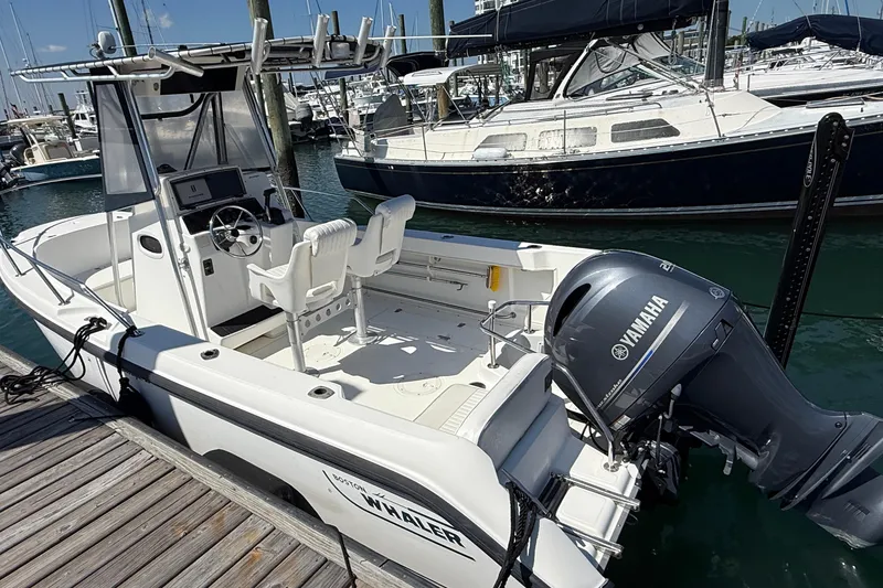 Slide: The Image of 2000 Boston Whaler 21 Outrage boat docked with Yamaha outboard motor. - 4