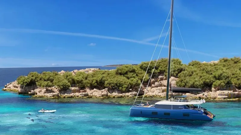 Slide: The Image of Luxurious 2026 Sunreef 100 yacht anchored near a scenic, lush island. - 8