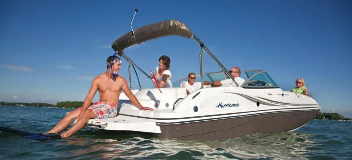 The Image of 2013 Hurricane Sundeck 217 IO boat on red trailer, parked outdoors. - 0