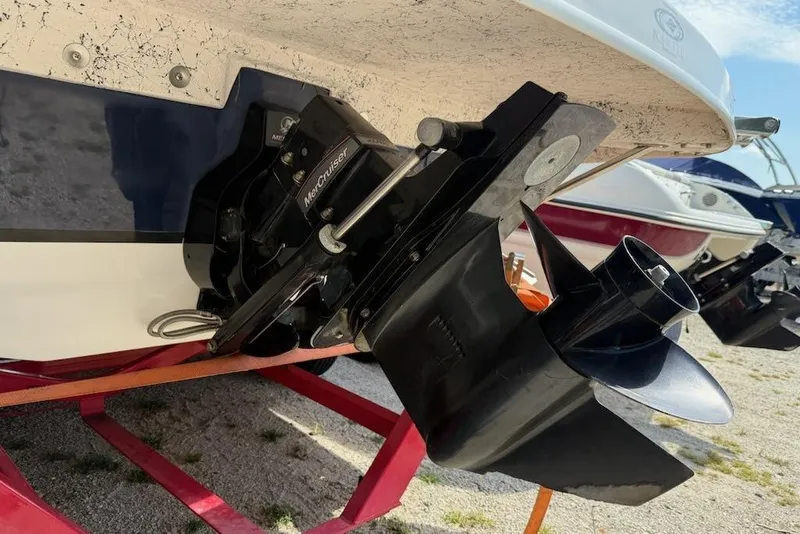 Slide: The Image of 2013 Hurricane Sundeck 217 IO boat with MerCruiser outdrive, parked on a trailer. - 10