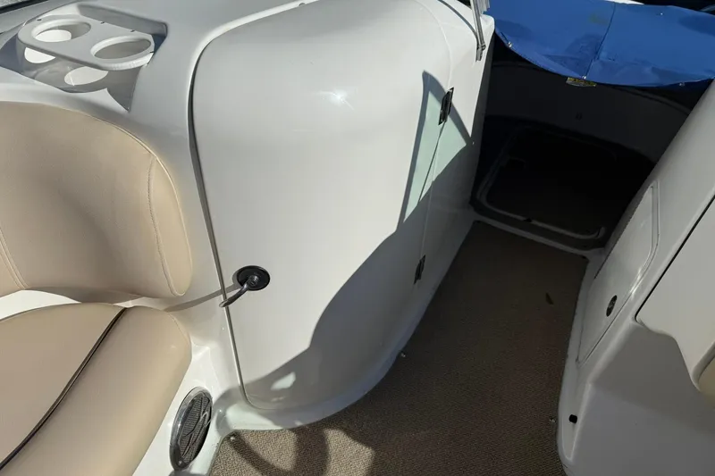 Slide: The Image of 2013 Hurricane Sundeck 217 IO interior with beige seating and cup holders. - 13
