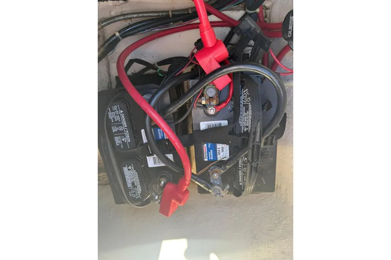 Slide: The Image of Battery compartment of 2013 Hurricane Sundeck 217 IO with cables and connectors. - 17