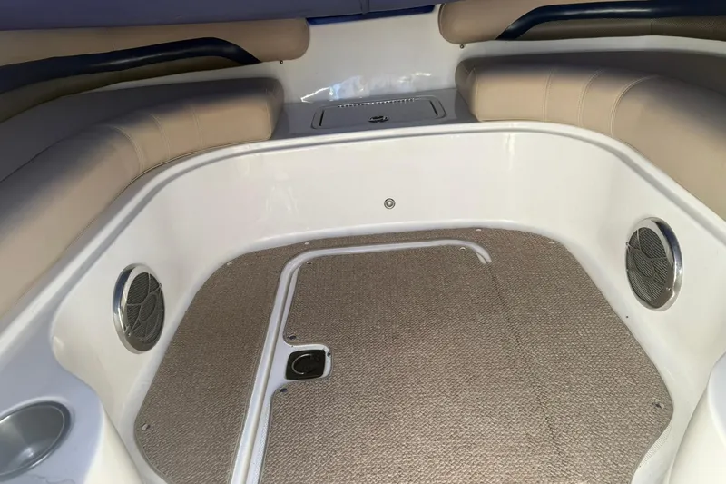 Slide: The Image of 2013 Hurricane Sundeck 217 IO interior with beige seating and carpeted flooring. - 7