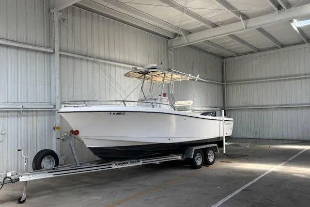 The Image of 2001 Edgewater 225CC boat on trailer in indoor storage facility. - 0