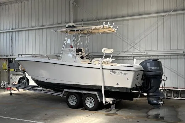 Slide: The Image of 2001 Edgewater 225CC boat on trailer in indoor storage with Yamaha outboard motor. - 14