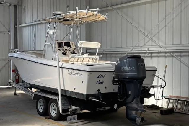 Slide: The Image of 2001 Edgewater 225CC boat on trailer in storage, featuring Yamaha outboard motor. - 15