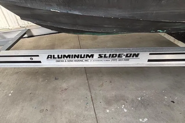 Slide: The Image of Aluminum boat trailer by Owens & Sons Marine, supporting Edgewater 225CC, 2001 model. - 17