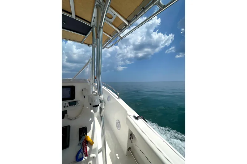 Slide: The Image of Edgewater 225CC boat cruising on calm ocean under a partly cloudy sky, 2001 model. - 18