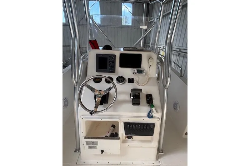 Slide: The Image of 2001 Edgewater 225CC boat console with steering wheel, navigation equipment, and control panel. - 3