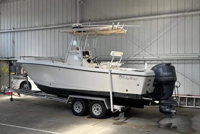 Slide: The Image of 2001 Edgewater 225CC boat on trailer in indoor storage with Yamaha outboard motor. - 6