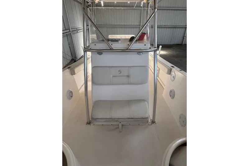 Slide: The Image of 2001 Edgewater 225CC boat interior with seating and metal frame in a storage area. - 8