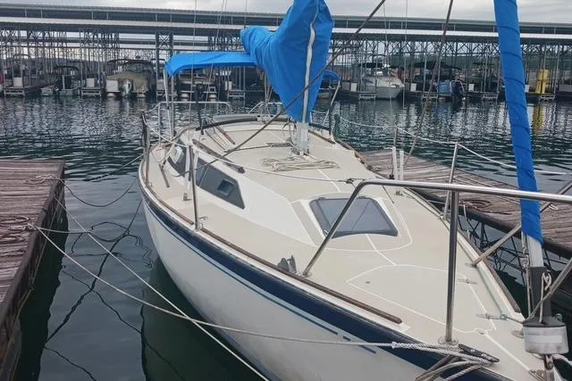 Slide: The Image of 1989 O'Day 272 sailboat docked at marina, featuring blue sail cover and sleek design. - 1