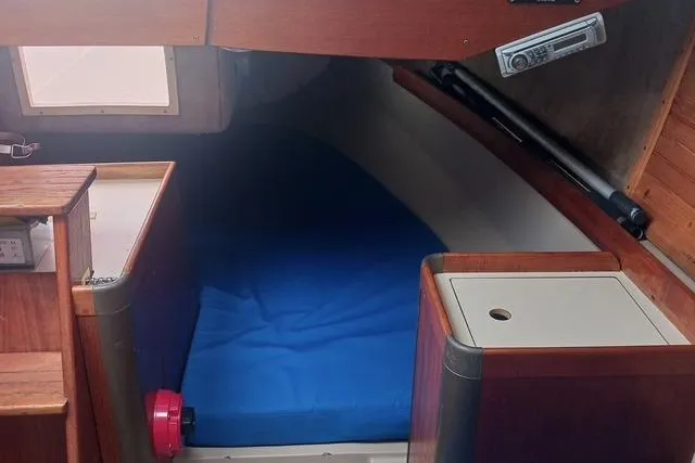 Slide: The Image of Interior cabin of a 1989 O'Day 272 sailboat with blue bedding. - 12