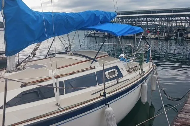 Slide: The Image of 1989 O'Day 272 sailboat docked with blue sail cover, marina background. - 3